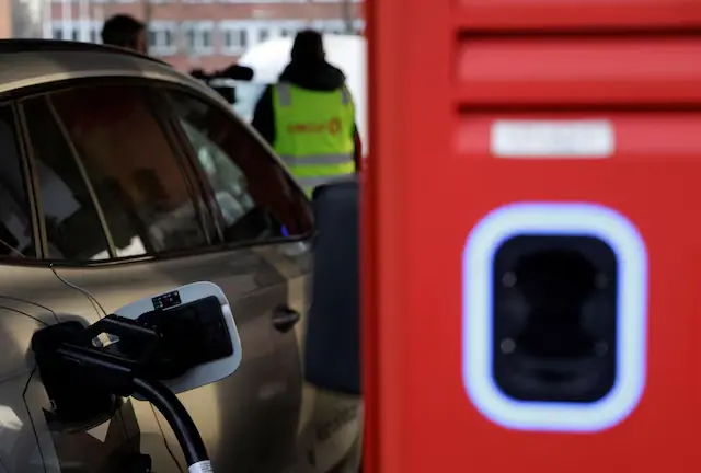 A car gets charged at a station that offers car charging points and fuel. &ndash; Reuters