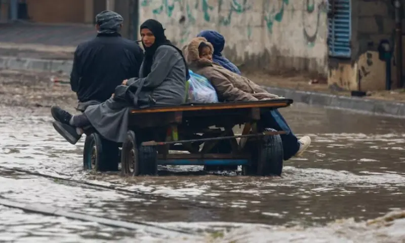 Displaced Palestinians make their way through a flooded street on a cart, during a rainy day in Nuseirat, central Gaza Strip, on December 11, 2025. Reuters file