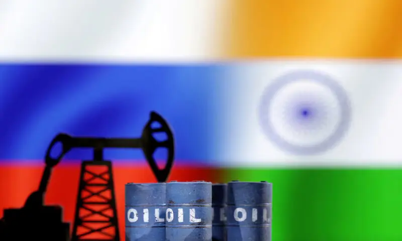 A model of an oil pump and oil barrels jack is seen in front of Russian and Indian flags in this illustration. &ndash; Reuters