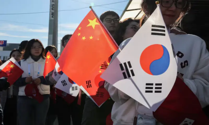 Pro-China supporters hold China and South Korea flags near Gimhae International Airport in Busan, South Korea. – Reuters Pro-China supporters hold China and South Korea flags near Gimhae International Airport in Busan, South Korea. – Reuters