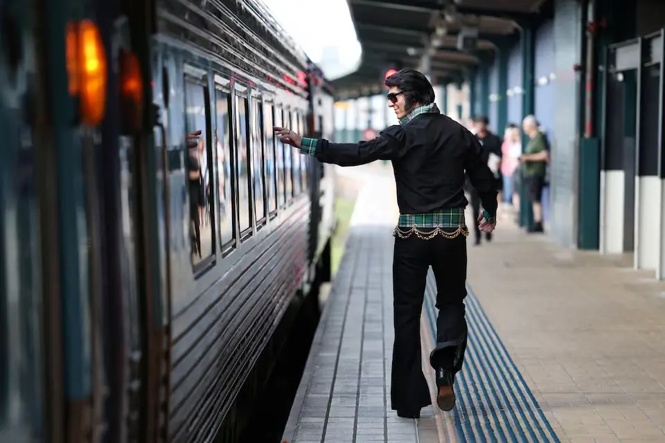 An Elvis tribute artist waves to Elvis fans on board the Elvis Express from Sydney’s Central Station. – Reuters An Elvis tribute artist waves to Elvis fans on board the Elvis Express from Sydney’s Central Station. – Reuters