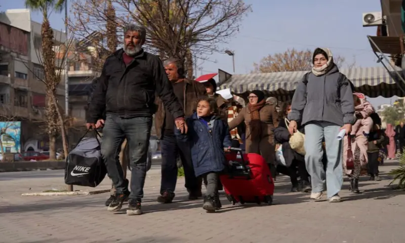 A group of civilians carry bags and belongings as they flee following renewed clashes between the Syrian army and the Syrian Democratic Forces, in Aleppo, Syria, on January 7, 2026. Reuters