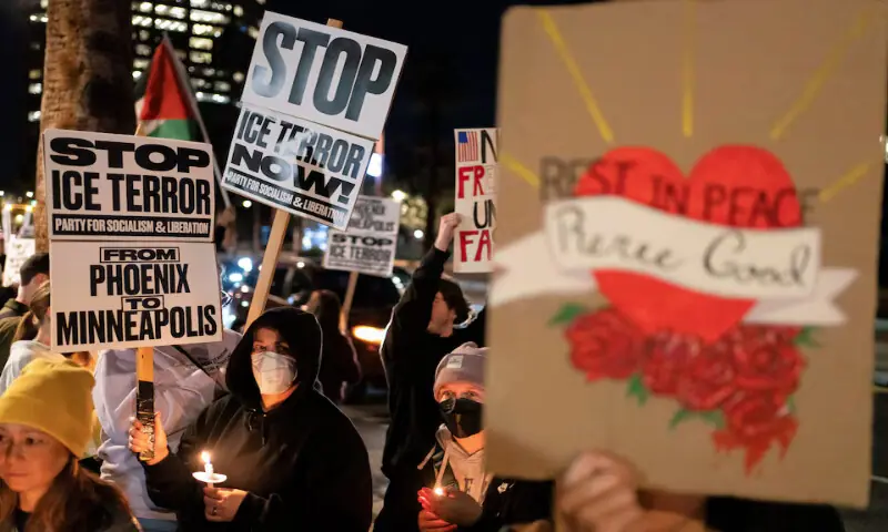 People hold signs and candles during a protest after the fatal shooting of Minneapolis resident Renee Nicole Good by an ICE agent outside the ICE Field Office in Phoenix, Arizona. &ndash; Reuters