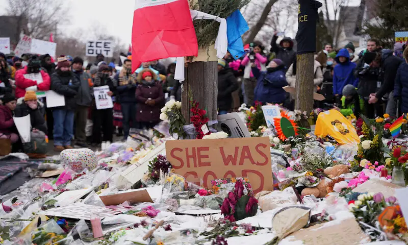 People stand before a makeshift memorial during an &ldquo;ICE Out of Minnesota&rdquo; rally and march in Minneapolis, Minnesota, US. &ndash; Reuters