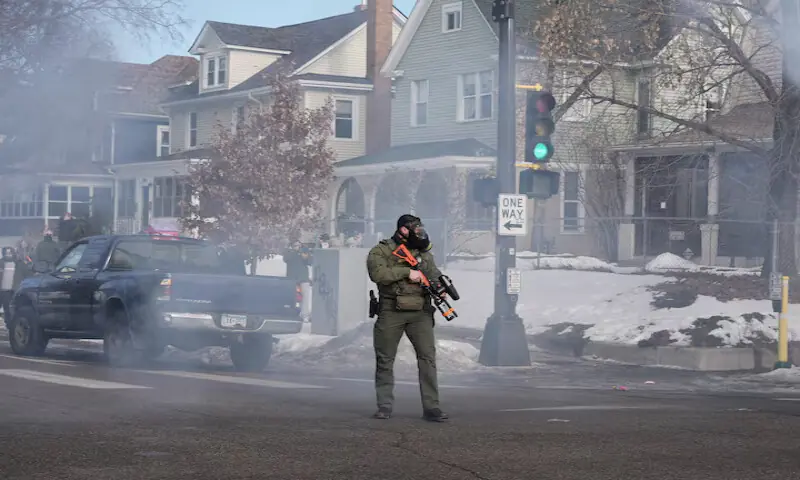 A federal agent holds a crowd-control weapon in Minneapolis, Minnesota. &ndash; Reuters