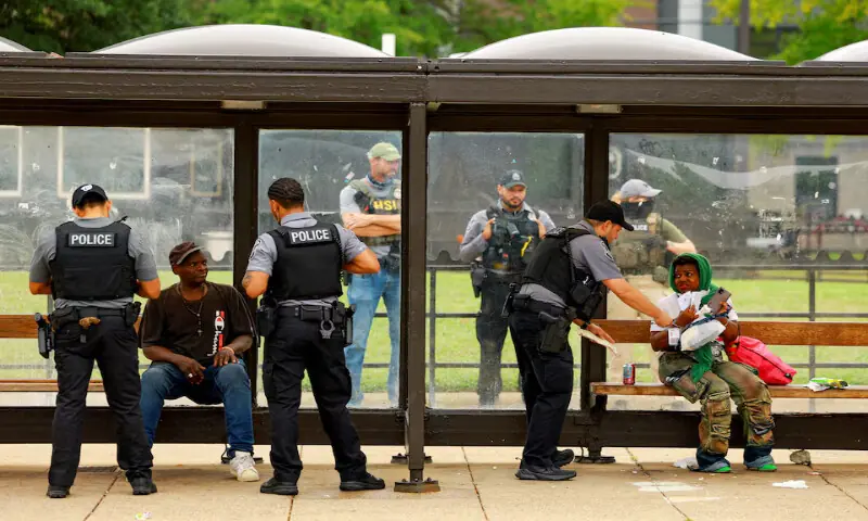 Police officers check individuals at the Anacostia bus station in Washington, DC. – Reuters Police officers check individuals at the Anacostia bus station in Washington, DC. – Reuters