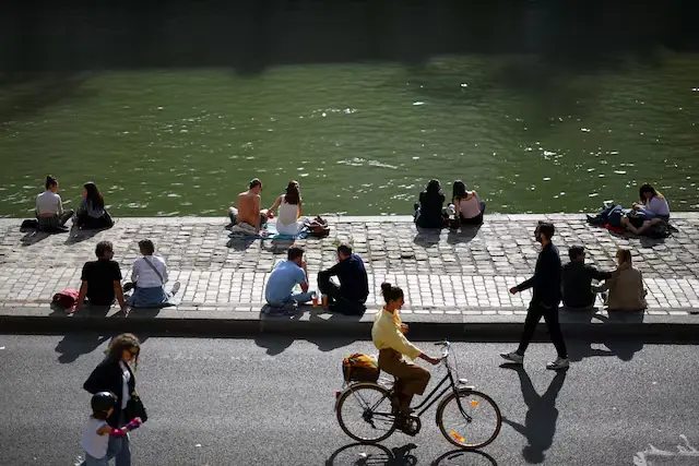 People on the banks of the River Seine in Paris, France. &ndash; Reuters