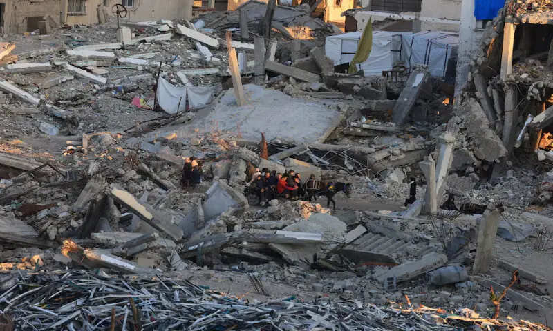 Palestinians move past the rubble of residential buildings destroyed during the war with Israel in Gaza City. &ndash; Reuters
