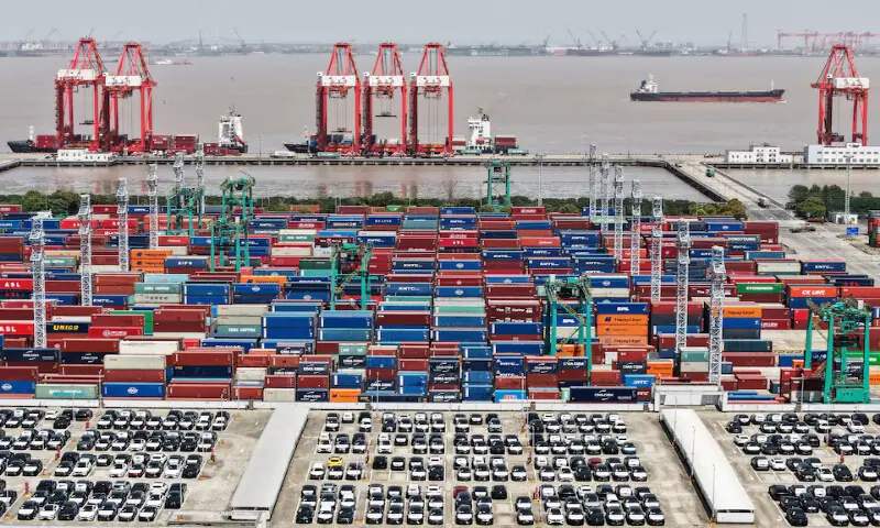 A drone view shows electric vehicles for export and containers sitting at a port in Shanghai, China. &ndash; Reuters file