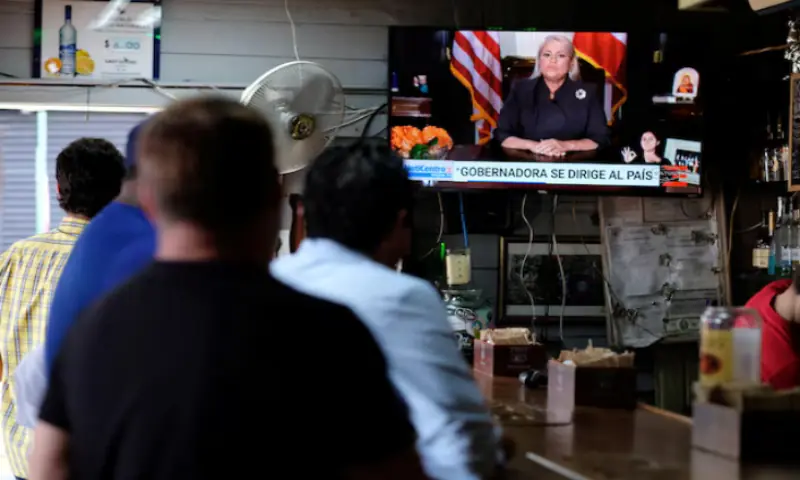 People watch television at a bar as Puerto Rico&rsquo;s Governor Wanda Vazquez Garced makes an address regarding the debt restructuring proposal filed in court by an oversight board, in San Juan, Puerto Rico. &ndash; Reuters