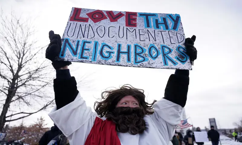 A demonstrator holds a sign during a protest in Minneapolis, Minnesota. &ndash; Reuters