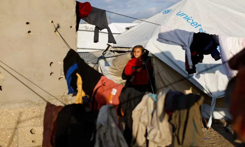 A child looks out from a tent as displaced Palestinians shelter in a tent camp in Deir Al Balah, central Gaza Strip. &ndash; Reuters