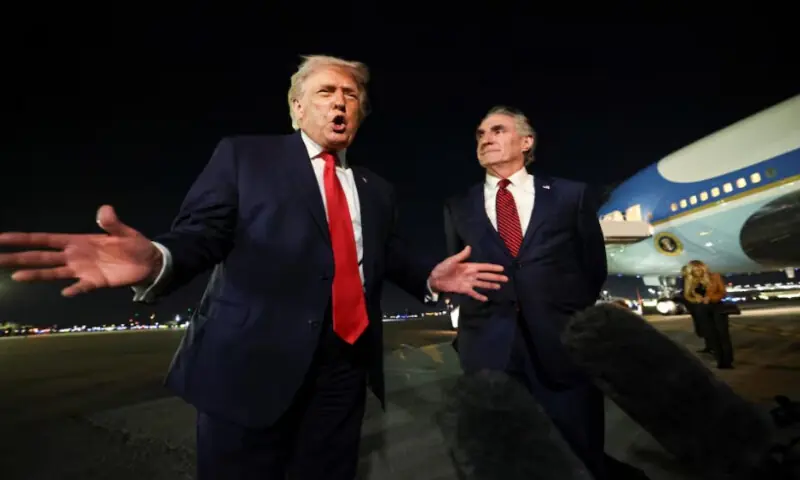 U.S. President Donald Trump speaks to members of the media, alongside Secretary of the Interior Doug Burgum, ahead of boarding Air Force One to depart for Washington, at Palm Beach International Airport in West Palm Beach, Florida, U.S., on January 19, 2026. Reuters