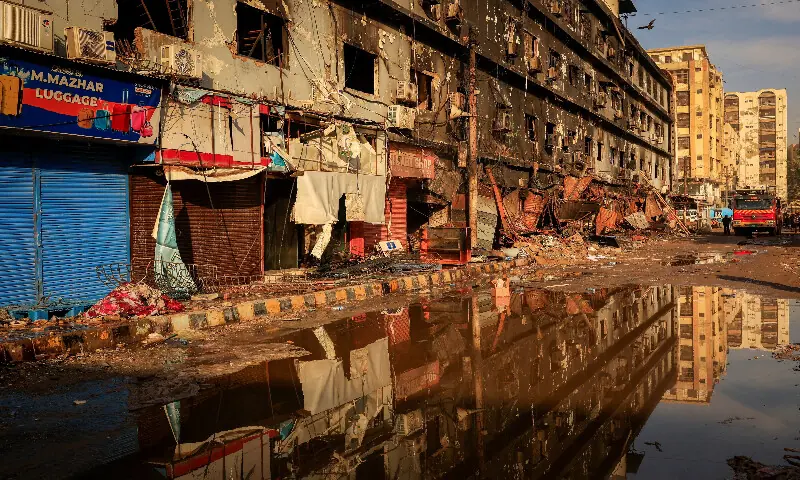A fire truck stands next to the site, following a massive fire that broke out in the Gul Plaza shopping centre in Karachi. &ndash; Reuters