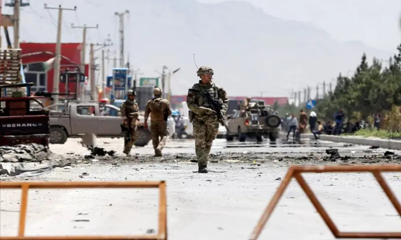 Afghan security forces and a British soldier with NATO-led Resolute Support Mission stand guard at the site of a suicide attack in Kabul, Afghanistan, on May 31, 2019. Reuters file