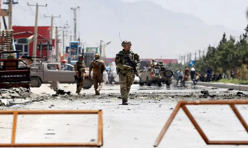 Afghan security forces and a British soldier with NATO-led Resolute Support Mission stand guard at the site of a suicide attack in Kabul, Afghanistan. &ndash; Reuters file