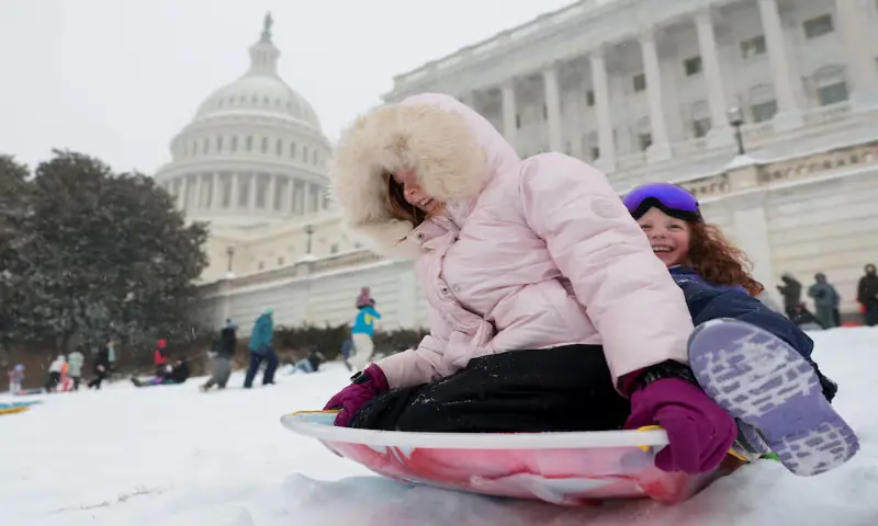 Children sled near the US Capitol building in Washington, DC. &ndash; Reuters