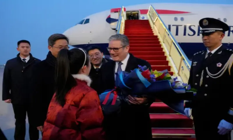 Britain&rsquo;s Prime Minister Keir Starmer receives a bouquet at an airport in Beijing, China, on January 28, 2026. Reuters