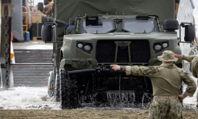 A US Navy Landing Craft Utility (LCU) unloads a Joint Light Tactical Vehicle (JLTV) as sailors guide it ashore during amphibious operations in Arroyo, Puerto Rico. &ndash; Reuters