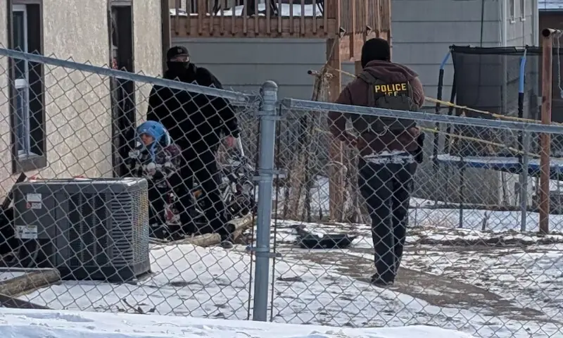 ICE agents stand next to a boy, who a witness identified as Liam Conejo Ramos, a five-year-old who school officials said was detained in Minneapolis, Minnesota, US. &ndash; Reuters