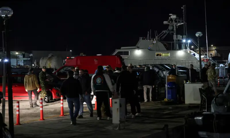 Greek emergency personnel wait to transfer the bodies of dead migrants following a migrant boat collision with the coast guard off the island of Chios in the port of Chios, Greece. &ndash; Reuters
