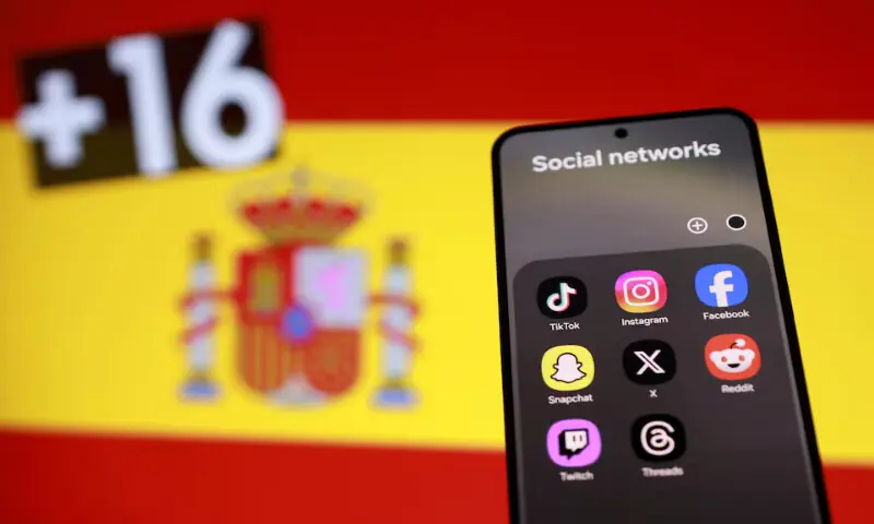 An illustration shows a Spanish flag, a smartphone with displayed social media app icons and text &ldquo;+16&rdquo;. &ndash; Reuters