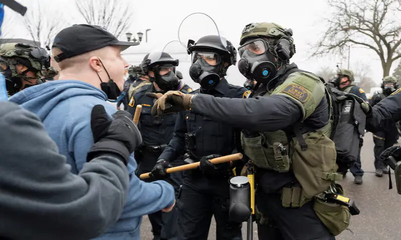 A protester faces law enforcement officers after federal immigration agents raided a home in St. Paul, Minnesota, US. &ndash; Reuters file