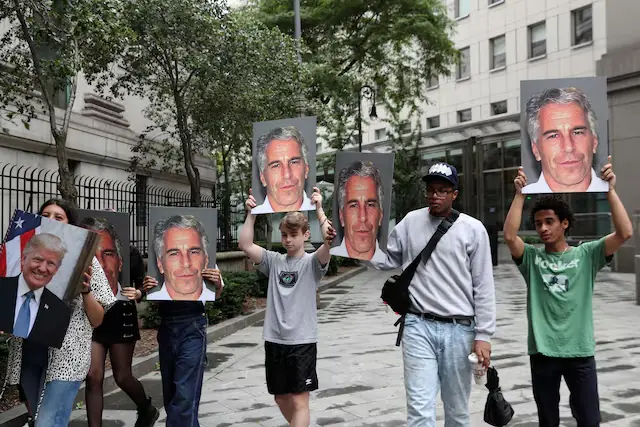 Demonstrators hold signs aloft protesting Jeffrey Epstein. &ndash; Reuters file