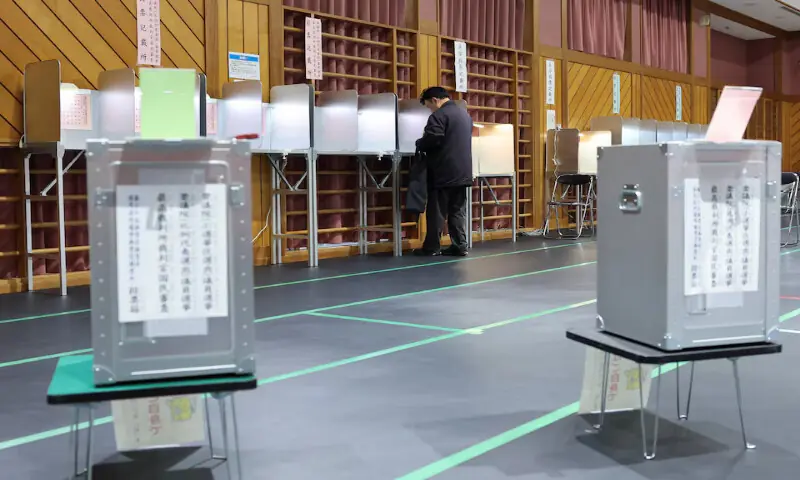 A voter prepares to cast their ballot at a polling station in Tokyo, Japan, on Sunday. &ndash; Reuters