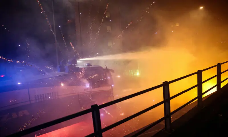 Fireworks explode near a police water cannon in Milan, Italy. &ndash; Reuters