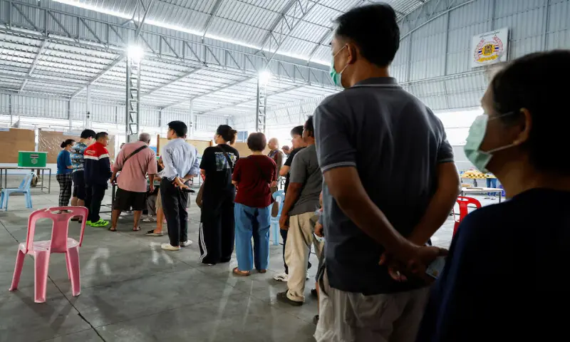 Voters stand in a queue at a polling station in Bangkok, Thailand, on Sunday. &ndash; Reuters