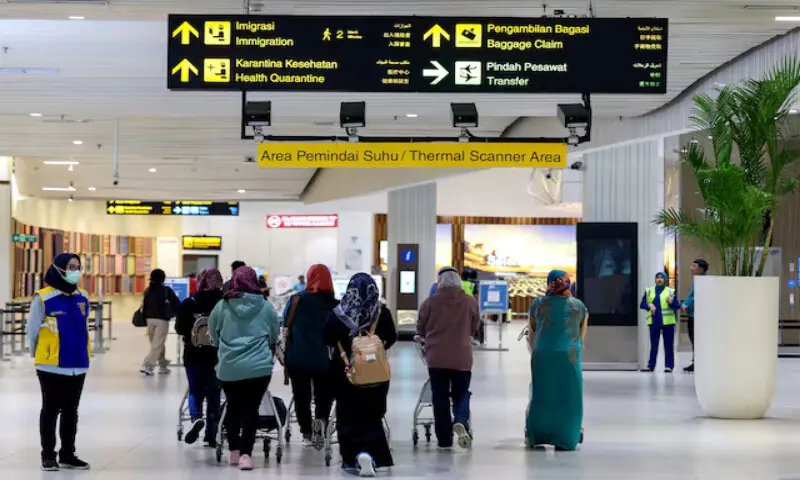 Passengers walk in the thermal scanner area at Soekarno Hatta International Airport, following the implementation of health screening for arriving passengers, in Tangerang near Jakarta, Indonesia. &ndash; Reuters