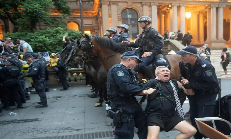 Police officers remove a protester as demonstrators gather at Town Hall Square to protest against Israeli President Isaac Herzog&rsquo;s visit to Australia in Sydney. &ndash; Reuters