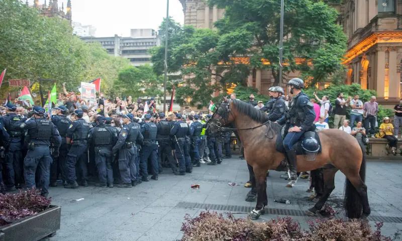 Police officers stand guard as demonstrators gather at Town Hall Square to protest against Israeli President Isaac Herzog&rsquo;s visit to Australia  in Sydney. &ndash; Reuters