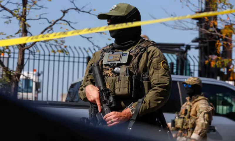A US Border Patrol officer stands behind tape during demonstrators&rsquo; standoff with US Immigration and Customs Enforcement (ICE) and federal officers in the Little Village neighbourhood of Chicago, Illinois, US. &ndash; Reuters