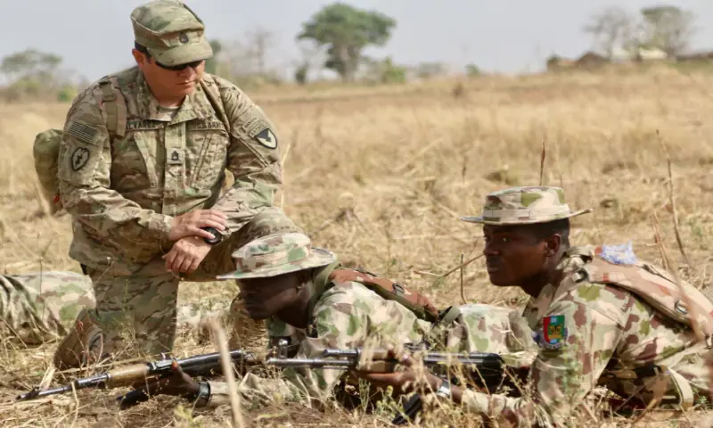 A US Army soldier (L) trains Nigerian Army soldiers at a military compound in Jaji, Nigeria. &ndash; Reuters