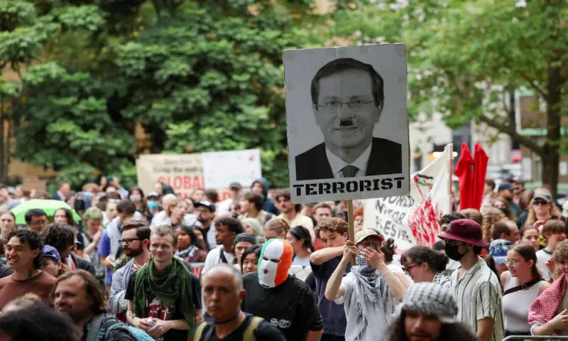 A demonstrator holds a sign with a picture depicting Israeli President Isaac Herzog during the &lsquo;Rally Against Police Brutality&rsquo; following yesterday&rsquo;s clashes with police during a protest against Herzog&rsquo;s state visit to Australia, in Sydney, Australia. &ndash; Reuters