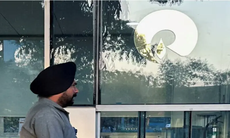 A guard walks past the Reliance Industries logo near the entrance of Dhirubhai Ambani Knowledge City in Navi Mumbai, on March 15, 2024. Reuters file