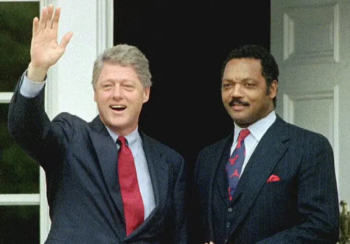 Bill Clinton waves while standing with Jesse Jackson after winning the 1992 presidential election. &ndash; Reuters
