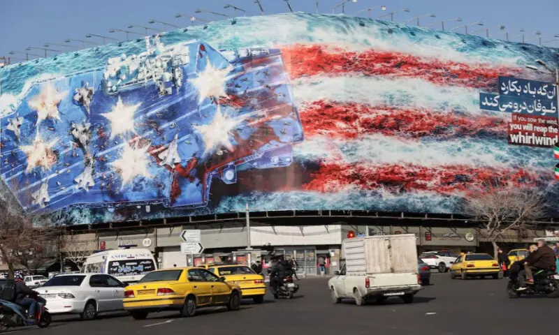 People walk past an anti-U.S. billboard on a street in Tehran, Iran, on February 17, 2026. Reuters file