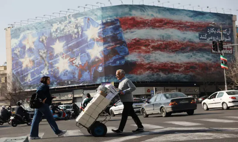 People walk past an anti-US billboard in Tehran, Iran. &ndash; Reuters