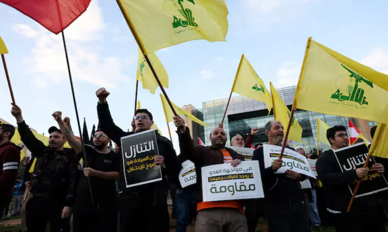Protesters hold placards and Hezbollah flags during a demonstration in Beirut condemning recent Israeli military actions in Lebanon. &ndash; Reuters