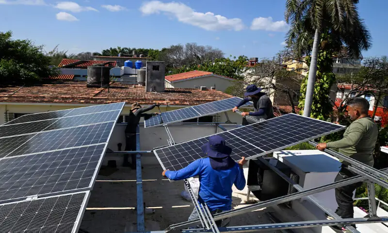 Workers install a solar panel on the rooftop of a private business establishment in Havana, Cuba. &ndash; Reuters