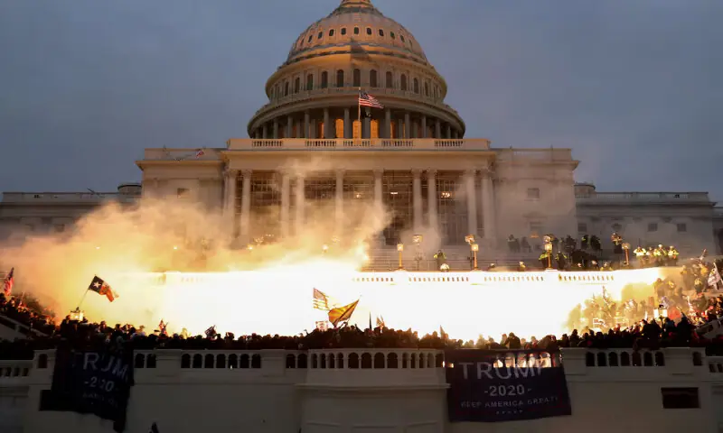 An explosion caused by a police munition is seen while supporters of US President Donald Trump riot in front of the US Capitol Building in Washington on January 6, 2021. &ndash; Reuters