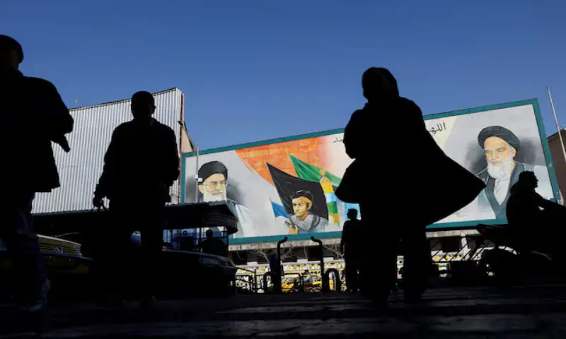 People walk near a mural featuring images of Iran&rsquo;s Supreme Leader Ayatollah Ali Khamenei and Ayatollah Khomeini on a street in Tehran, Iran. &ndash; Reuters