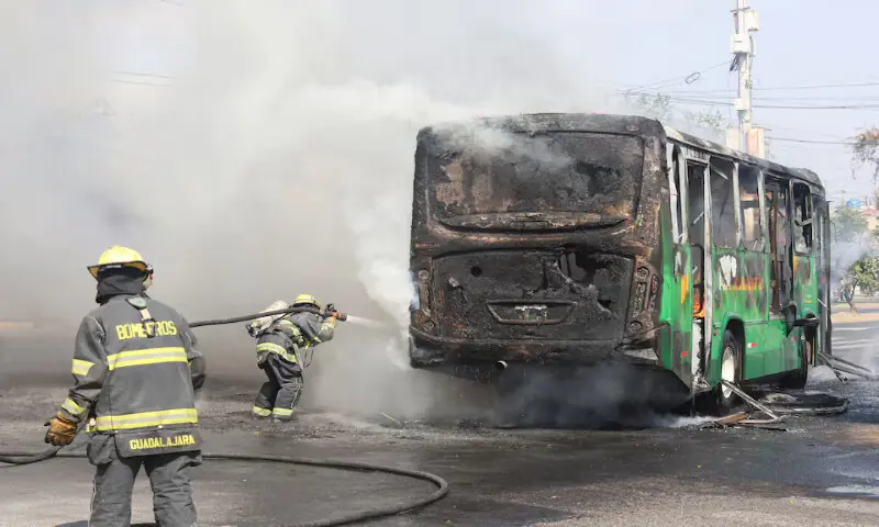 Firefighters work to extinguish flames from a vehicle used by organised crime members as roadblock following a series of detentions by federal forces in Guadalajara, Mexico. &ndash; Reuters