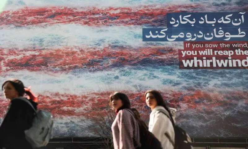 Iranian women walk past a billboard in Tehran, Iran. – Reuters Iranian women walk past a billboard in Tehran, Iran. – Reuters