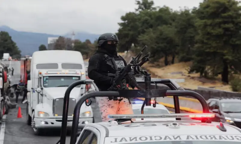 A member of the National Guard stands on a vehicle at the site on the highway connecting Mexico City with the state of Puebla. Reuters