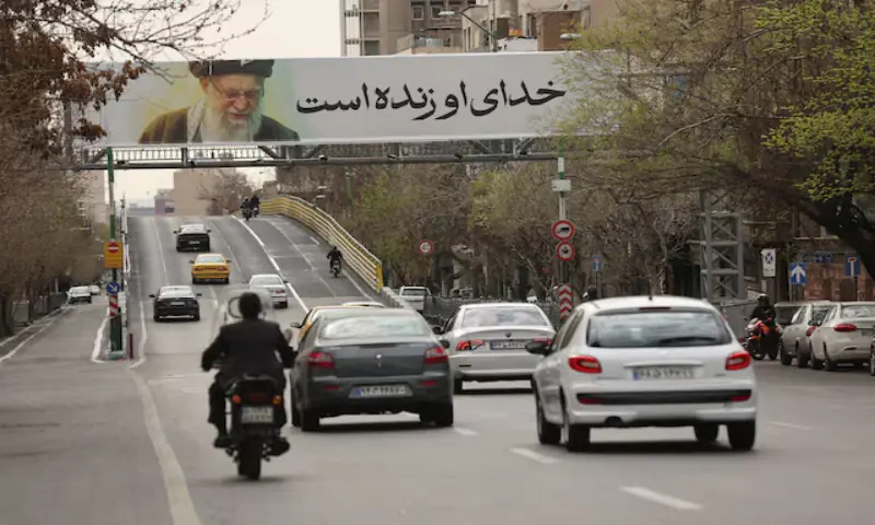 People drive near a banner of Iran’s late Supreme Leader Ayatollah Ali Khamenei on a street in Tehran, Iran. – Reuters People drive near a banner of Iran’s late Supreme Leader Ayatollah Ali Khamenei on a street in Tehran, Iran. – Reuters