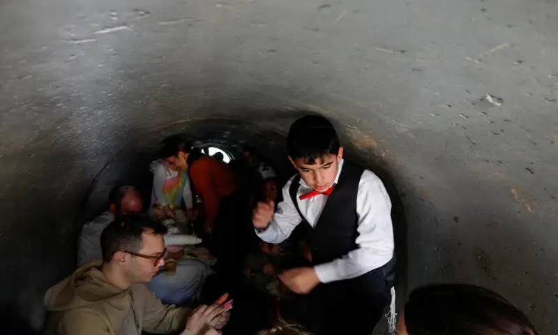 Israelis take cover in a tunnel following alerts of incoming projectiles in Shoresh, Israel. &ndash; Reuters